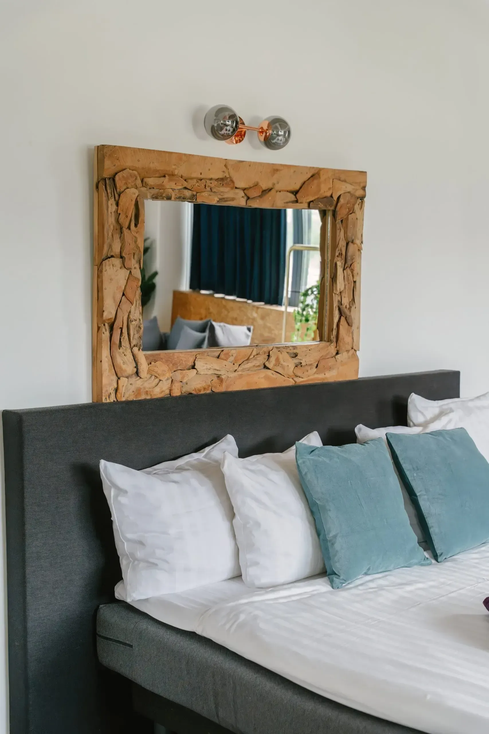 Bedroom detail with mirror and timber