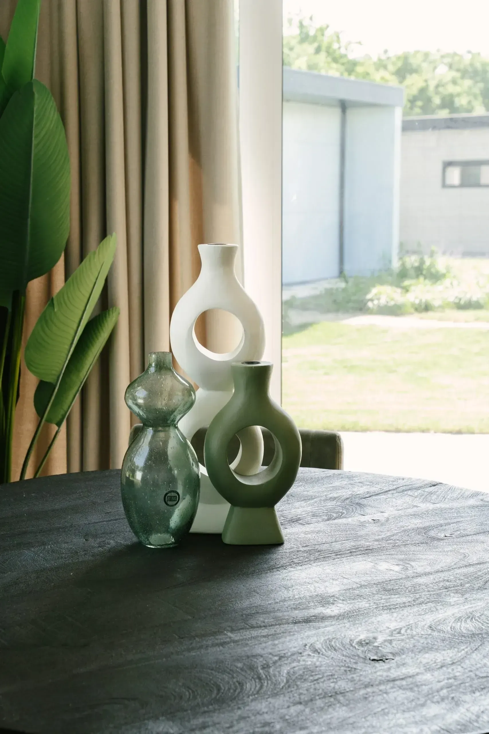 Morning light on a dark wooden table with ceramics