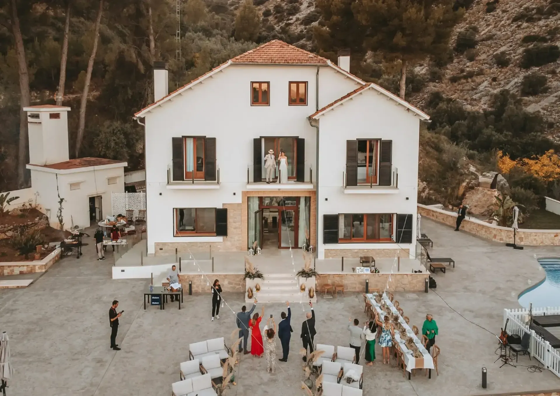 A wedding table set along the terrace between the mountains