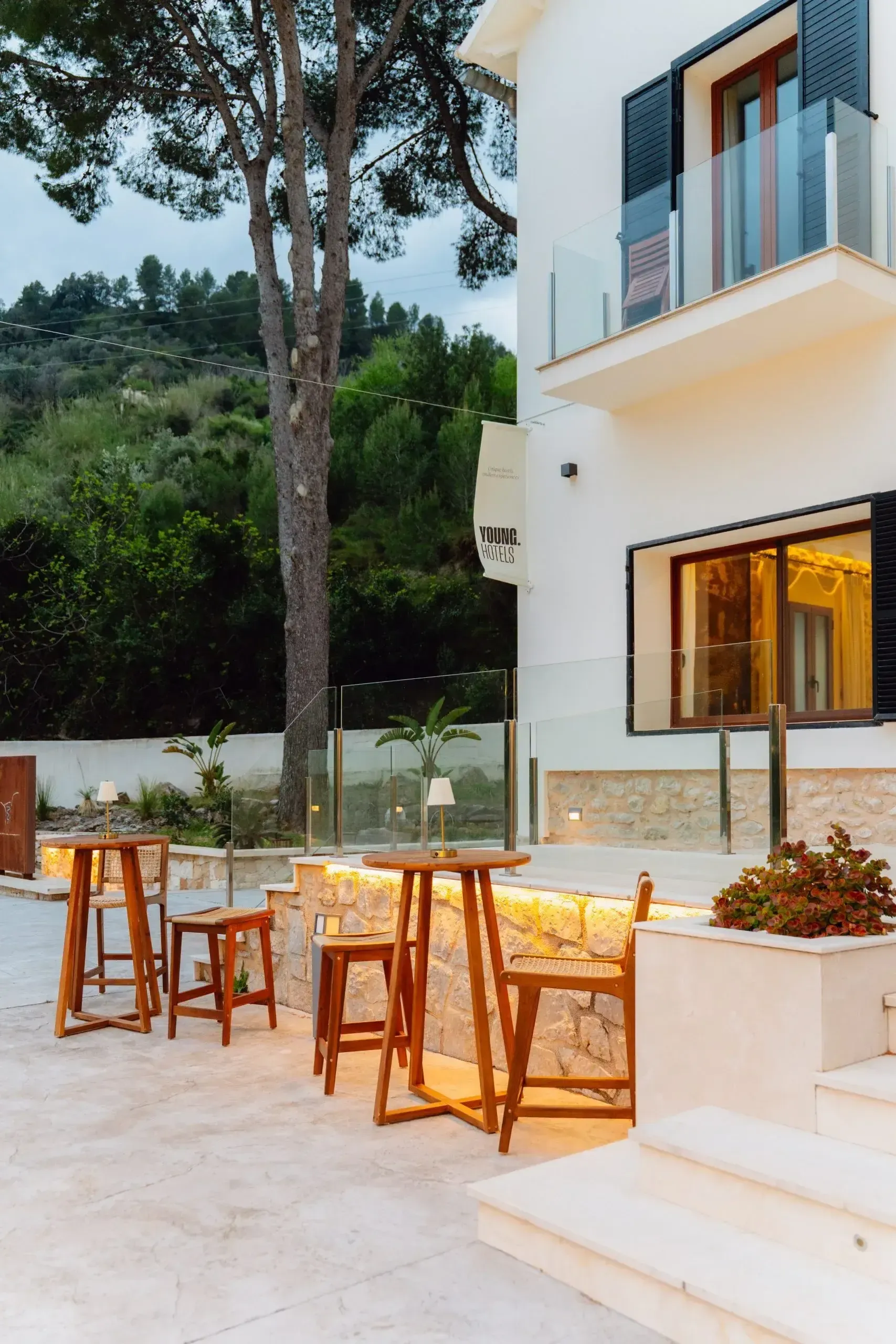 A long table set on a warm terrace above the valley