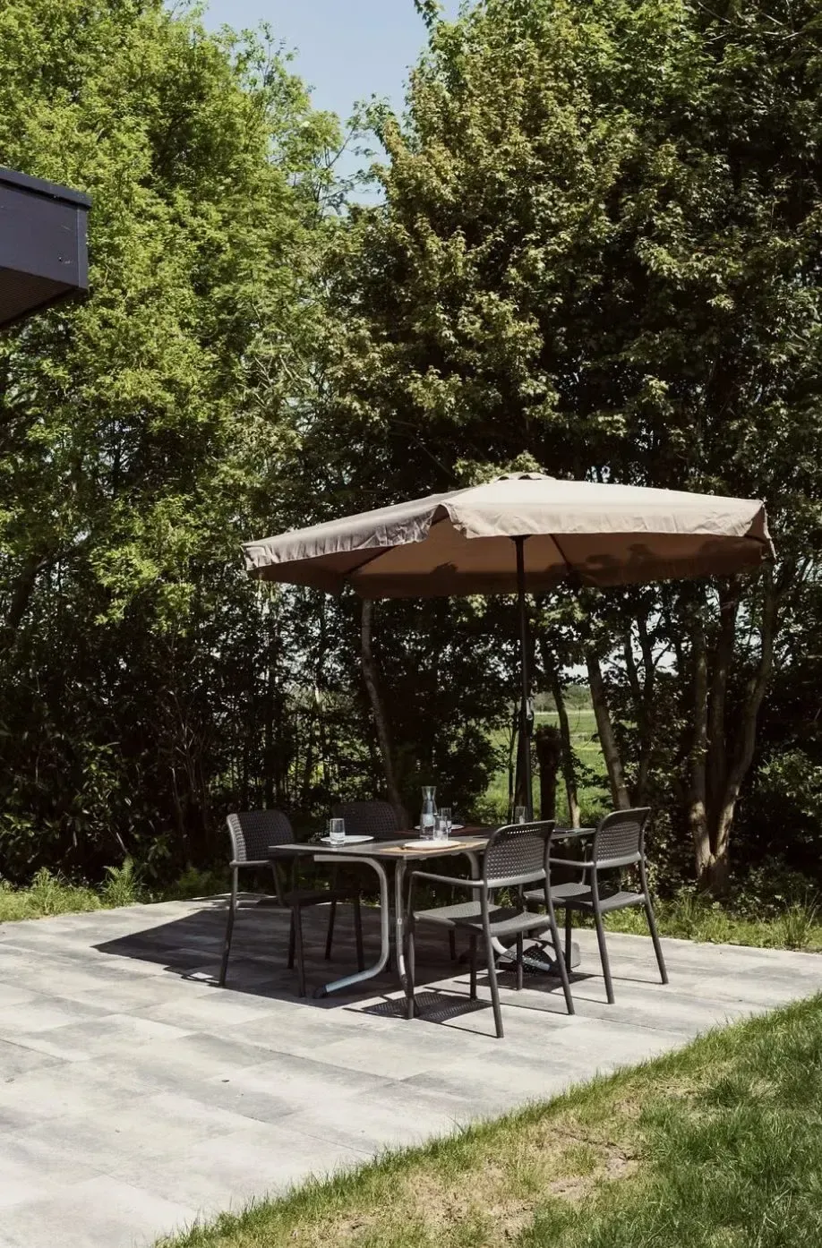 A shaded terrace with parasol