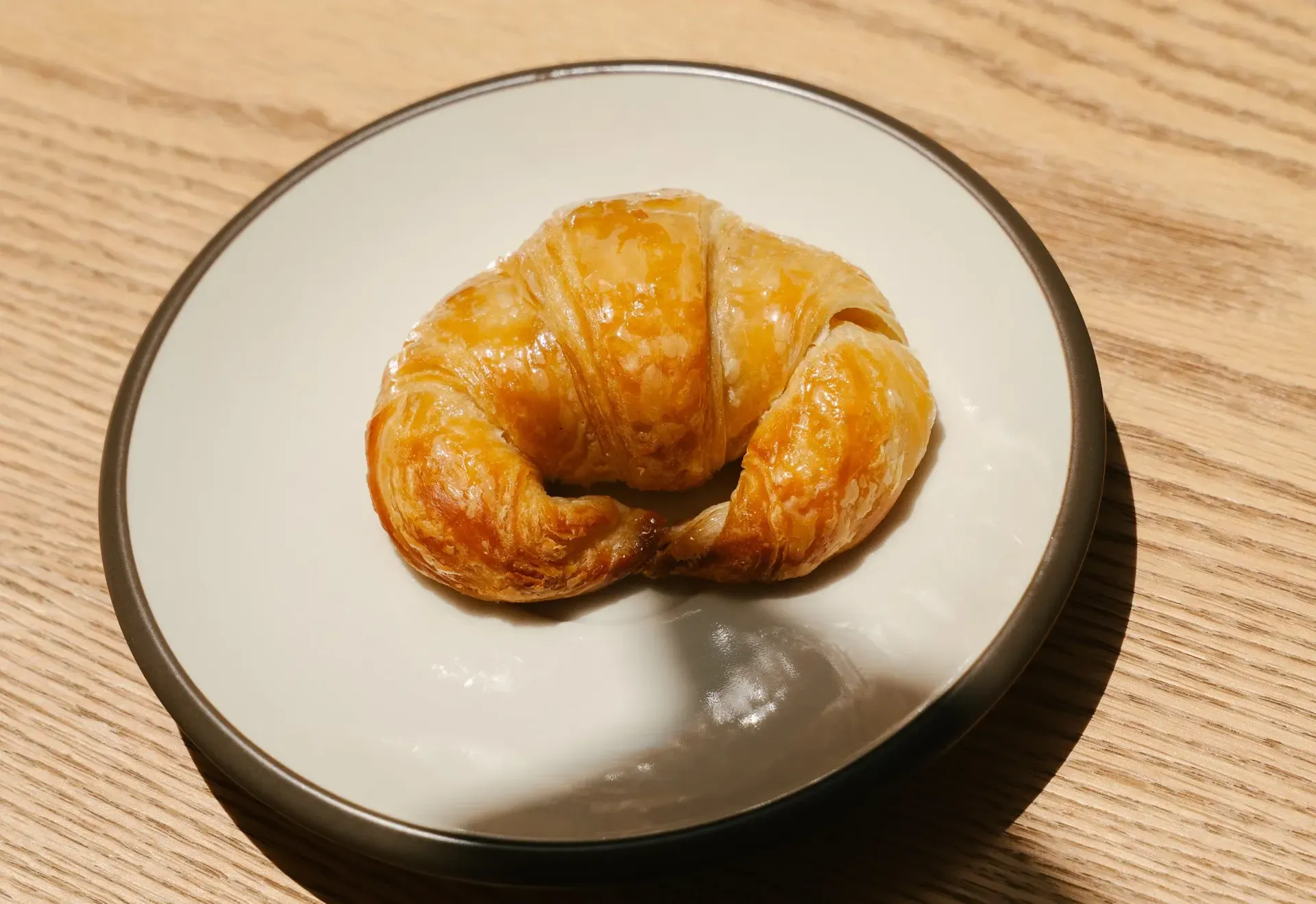 A freshly baked croissant served on a plate